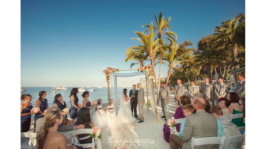 Landscape view a wedding ceremony arranged outdoors with a ocean backdrop at Catalina Island Company