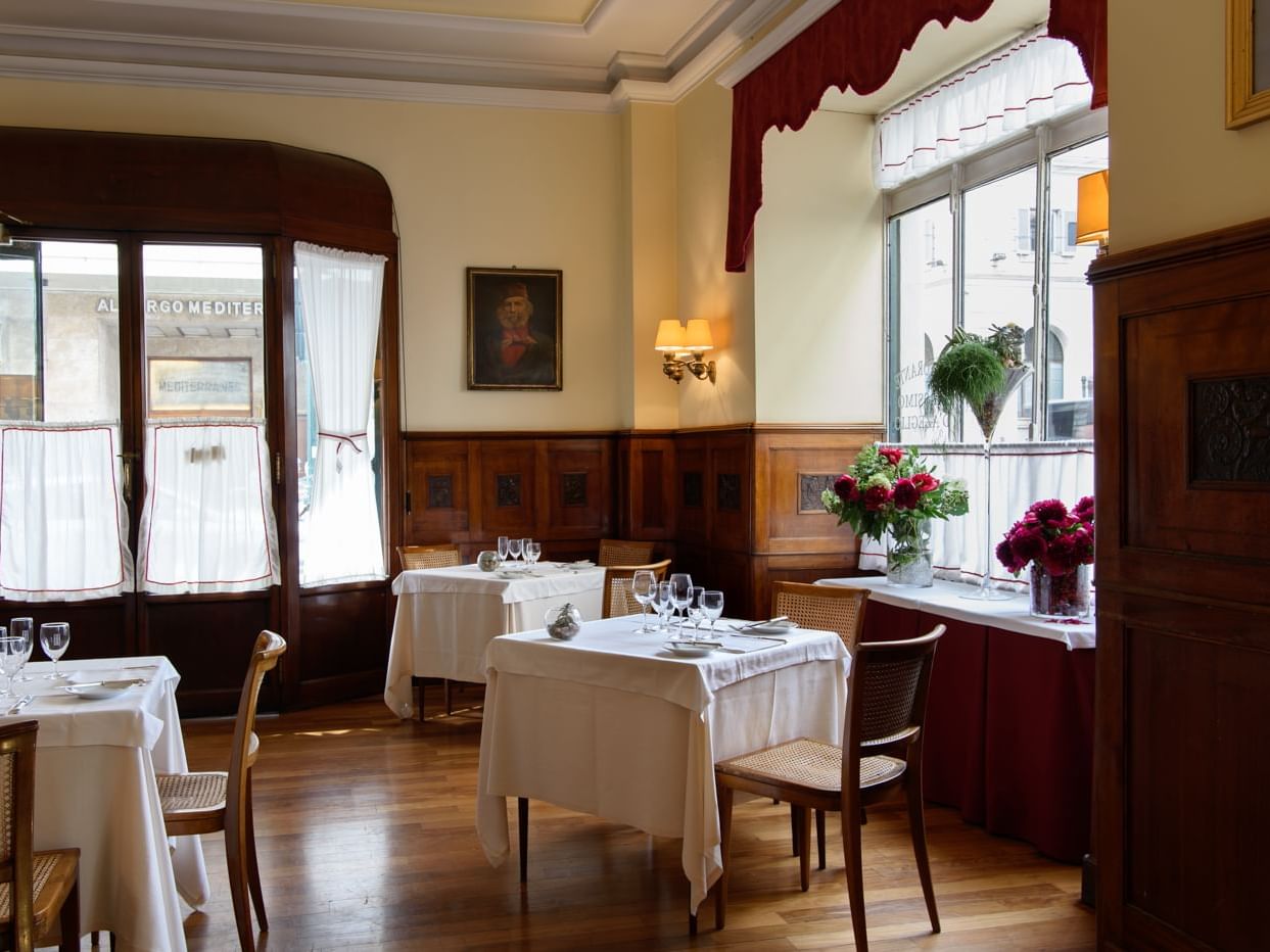 Massimo d’Azeglio Restaurant with wooden paneling and large windows at Bettoja Hotel Massimo D´Azeglio