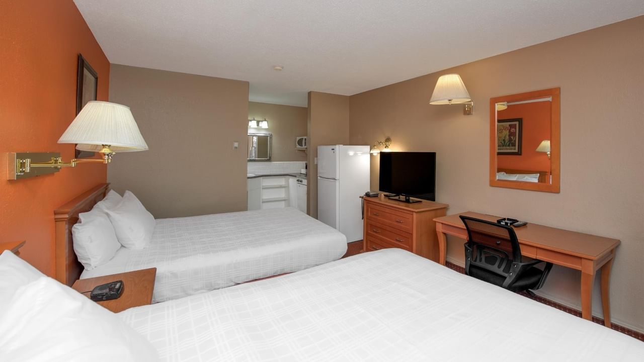 Guest room at Coast Red Deer Hotel with two queen beds, desk and TV
