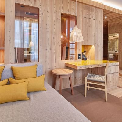 Loft Suite, Bed & work desk at Falkensteiner Hotel Kronplatz