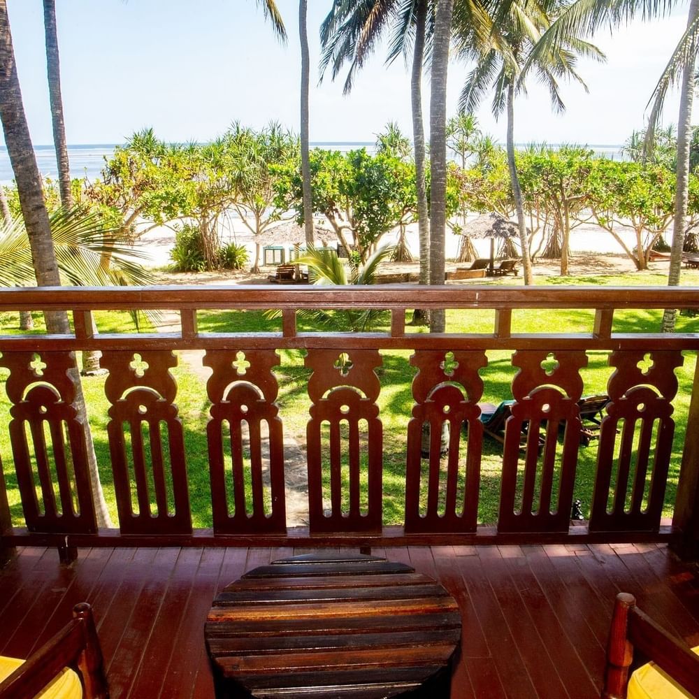 Wooden balcony with ocean view and tropical scenery at Serena Beach Resort & Spa in Mombasa.
