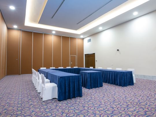 Spacious event room Molino del Rey with blue-covered tables and chairs at Camino Real Guadalajara in Zapopan