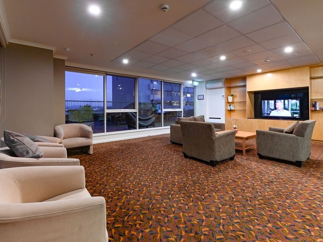 TV lobby area with outside view at Nesuto Canberra Apartment Hotel