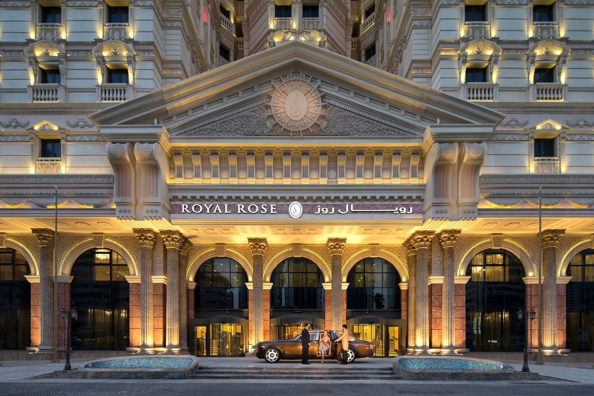 Concierge opening a car door at Royal Rose Hotel main entrance