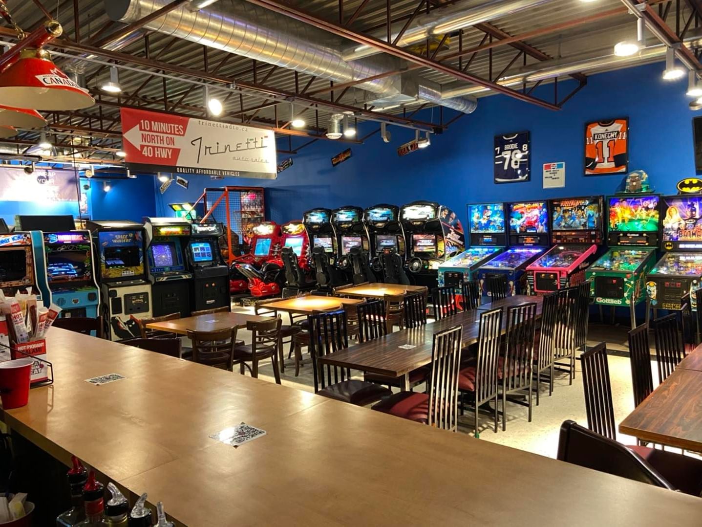 Barnetti's Arcade filled with arcade machines and tables near Retro Suites Hotel