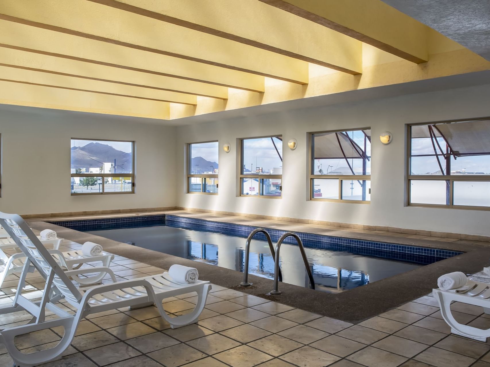 Indoor pool area with pool beds at Fiesta Inn