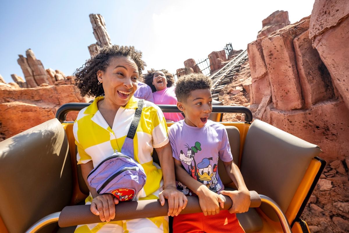 People in a roller coaster cart at Walt Disney World's Magic Kingdom near Lake Buena Vista Resort Village & Spa