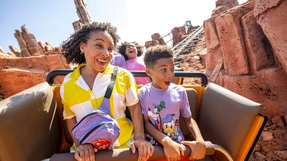 People in a roller coaster cart at Walt Disney World's Magic Kingdom near Lake Buena Vista Resort Village & Spa