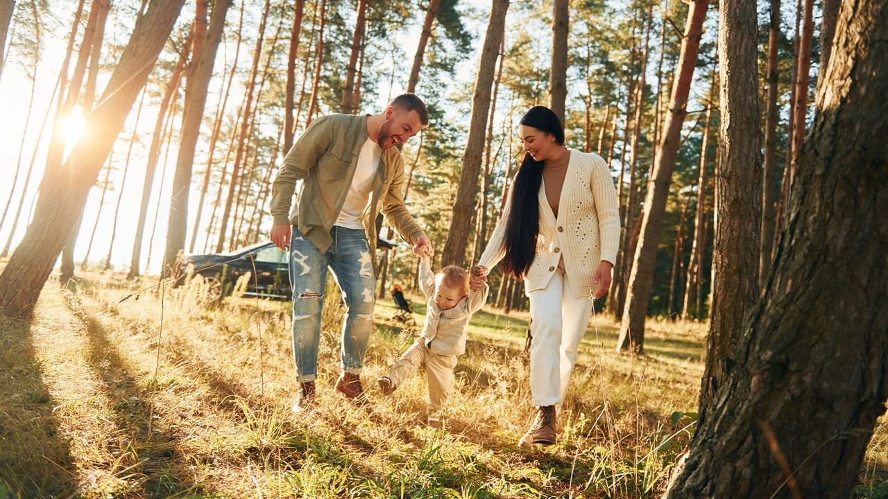 Family of three walking in forest