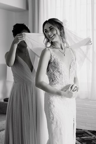 Bridesmaid adjusting bride's veil at the Hotel at Old Town