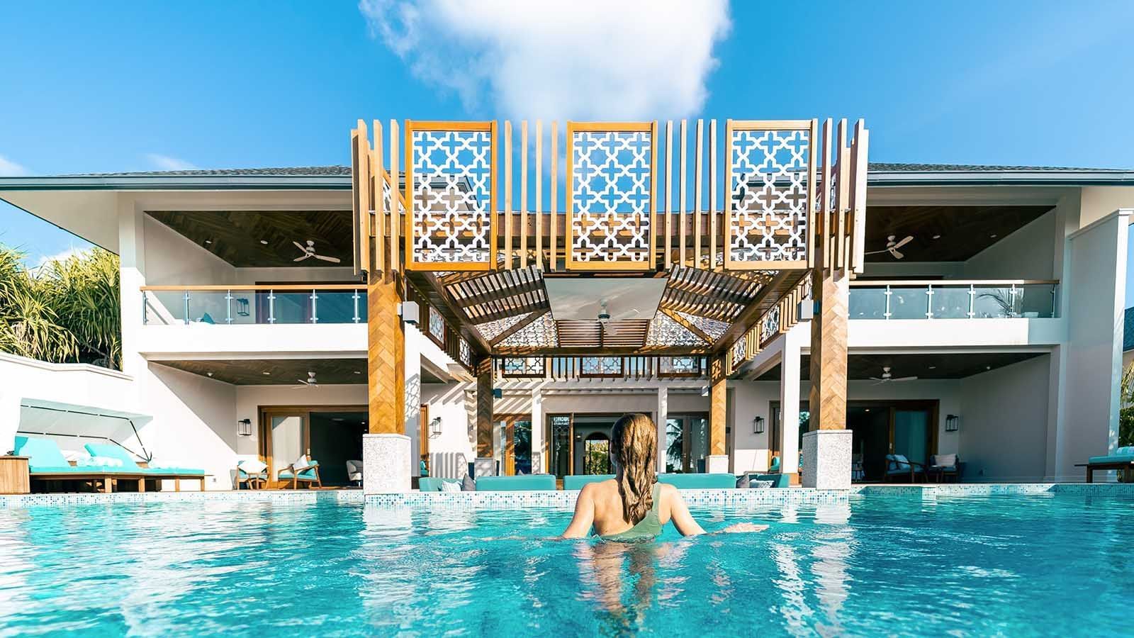 Lady relaxing in the pool, The Signature Collection by Hideaway