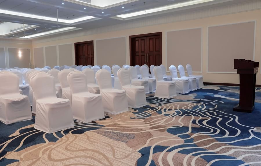 Meeting room with rows of white chairs at Warwick Hotel & Spa - Jeddah.