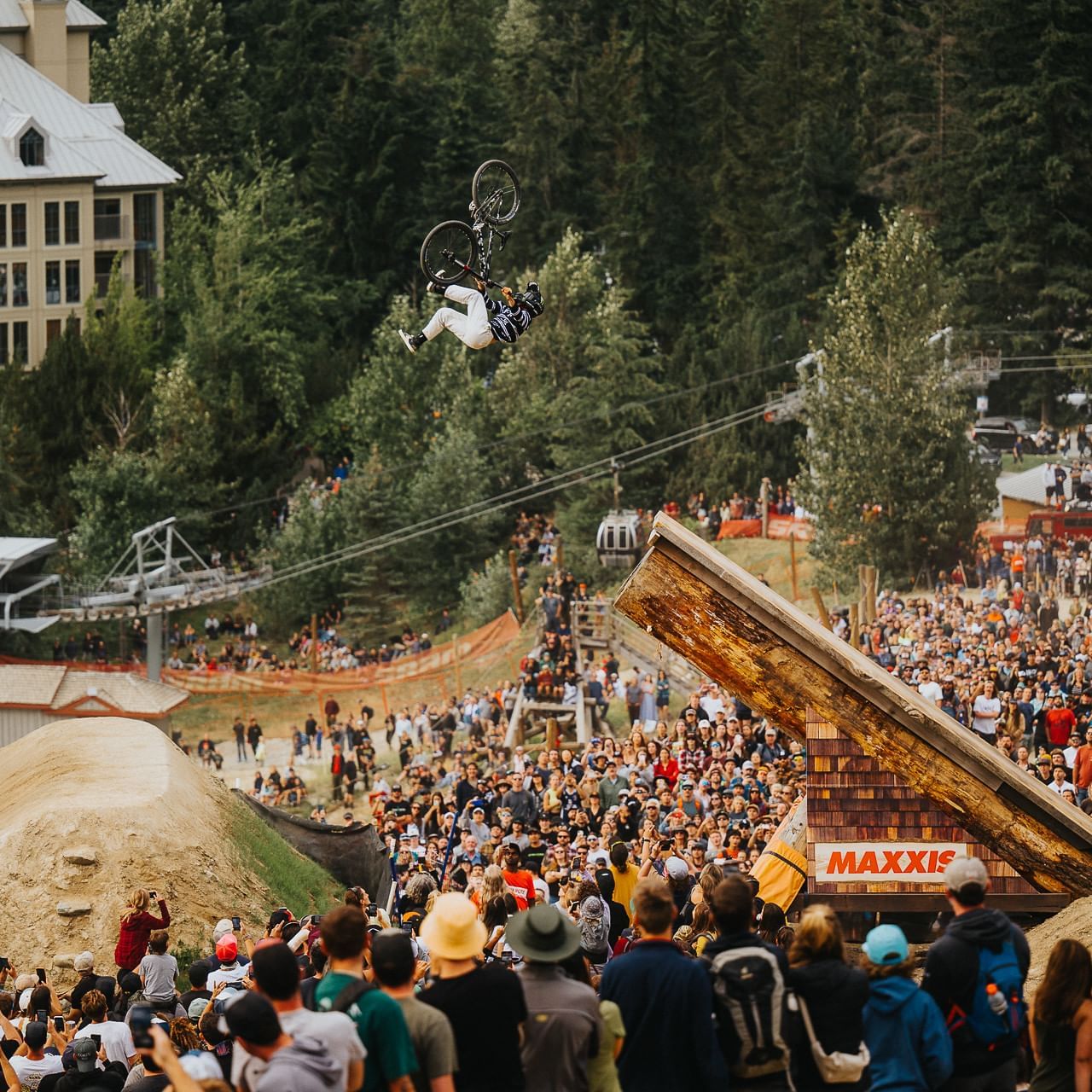 Cyclist in the air over a crowd of people at Whistler Crankworx Festival near Blackcomb Springs Suites