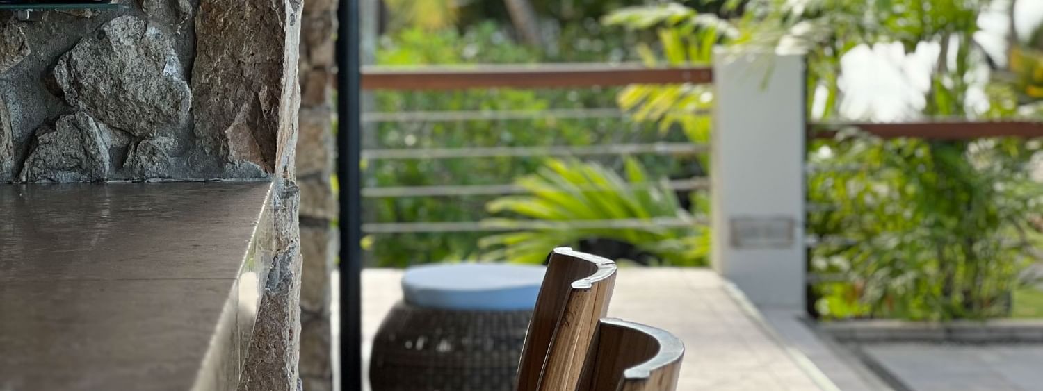 Chairs at the Sunset Terrace Bar with a tropical view at Warwick Fiji Resort and Spa, Korolevu