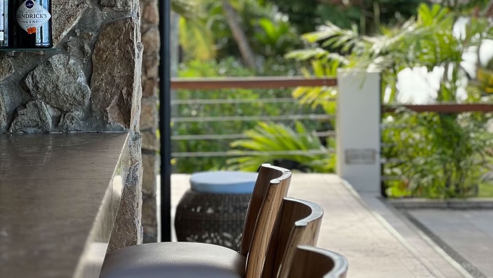 Chairs at the Sunset Terrace Bar with a tropical view at Warwick Fiji Resort and Spa, Korolevu.