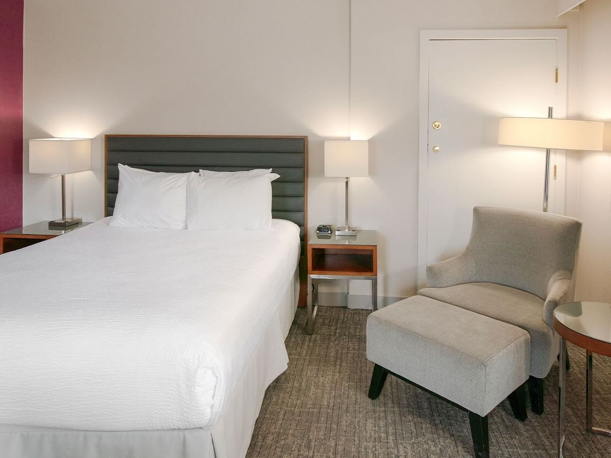 A hotel suite with a queen bed.