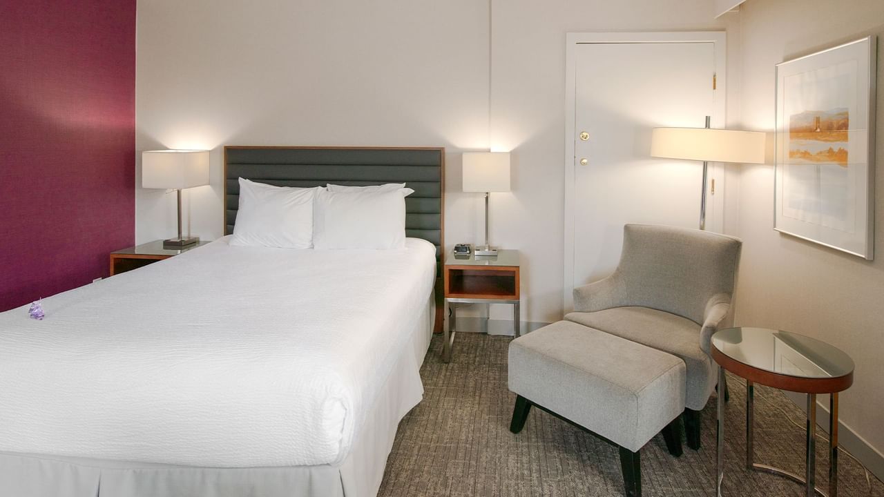 A hotel suite with a queen bed.