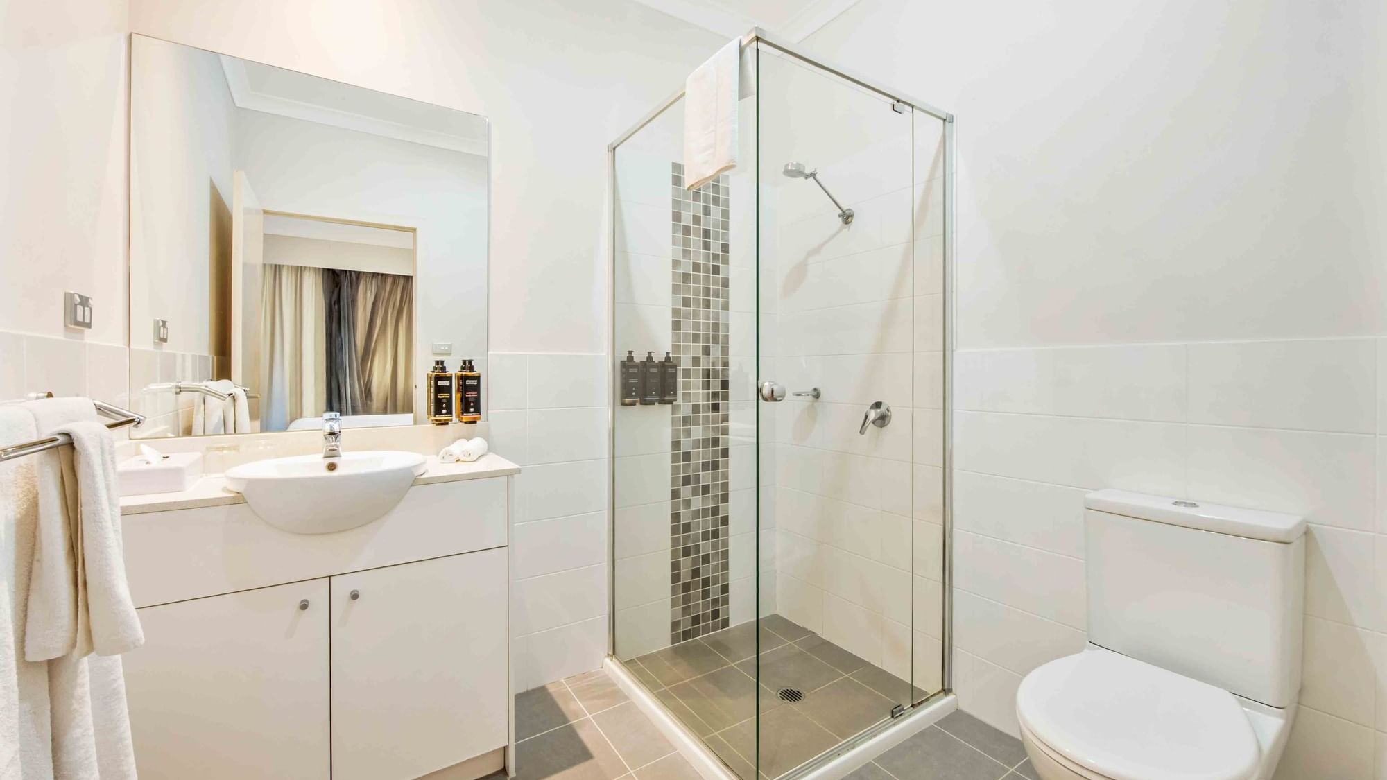 Bathroom with white vanity, basin, and glass shower partition in Two Bedroom Apartment at Mercure Kooindah Waters