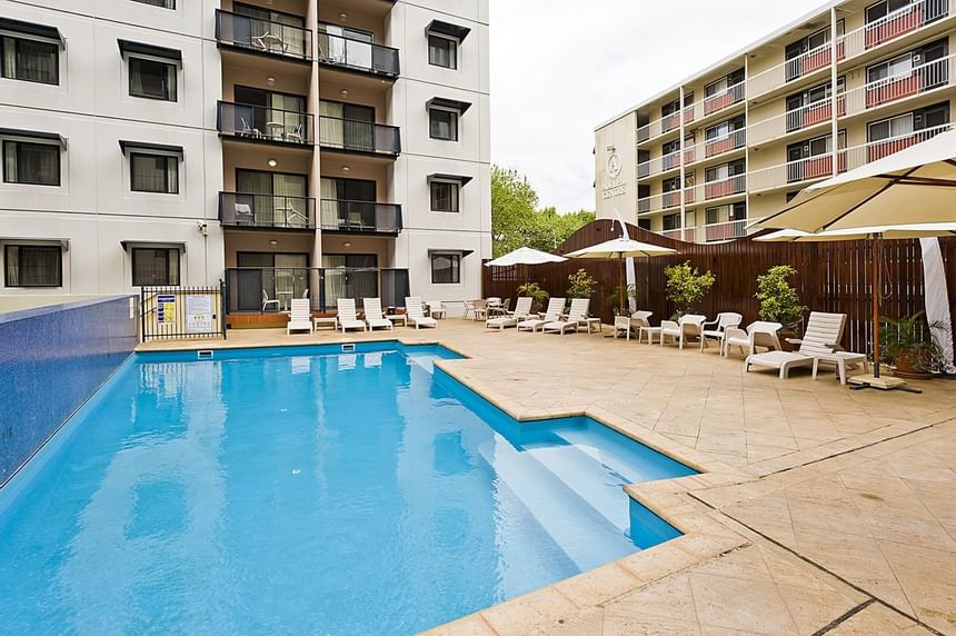 Sunbeds by the outdoor pool area at Nesuto Mounts Bay