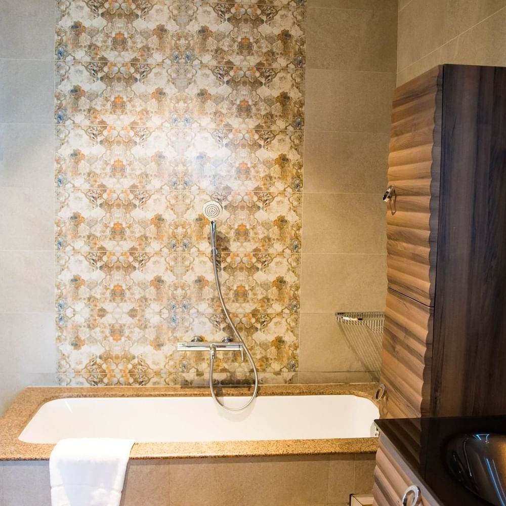 Elegant bathroom with tub and shower at Lake Victoria Serena Golf Resort & Spa in Kampala.