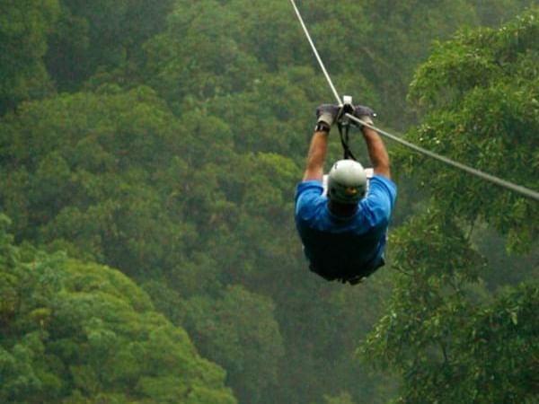 Zip Lining above lush forest near Cala Luna Boutique Hotel