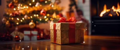 Close-up of a gift box by the Christmas tree at Warwick Hotels and Resorts