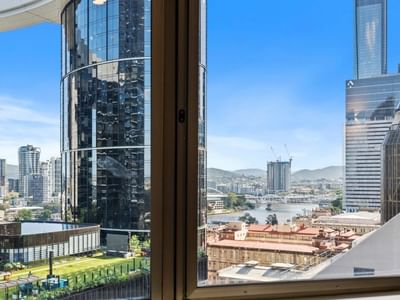 Panoramic city view with modern buildings and river at UniLodge Brisbane City.