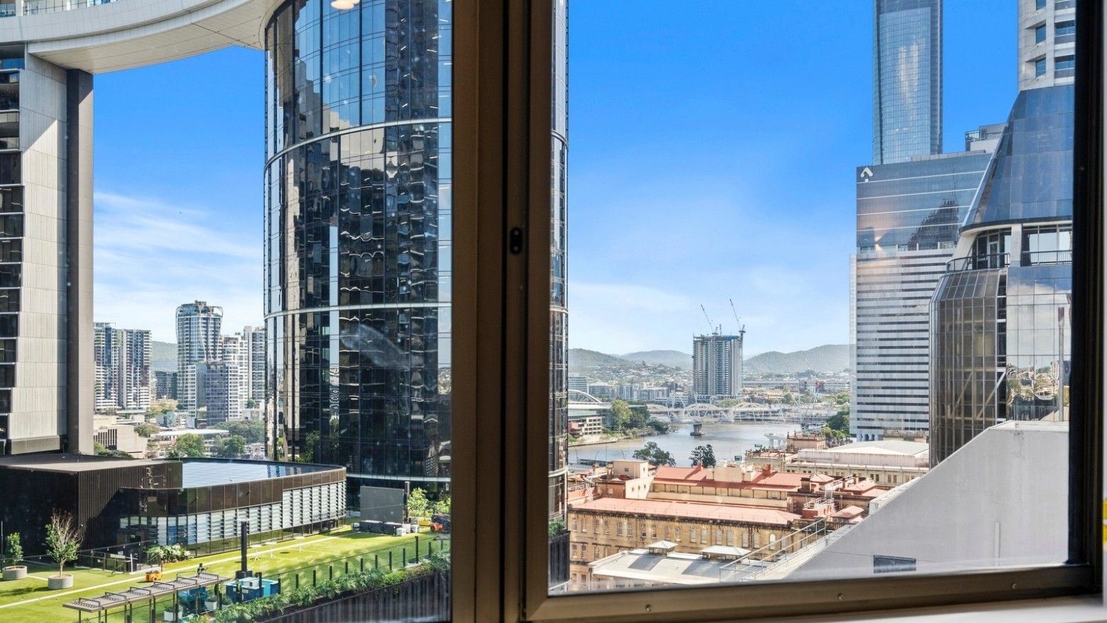 Panoramic city view with modern buildings and river at UniLodge Brisbane City.