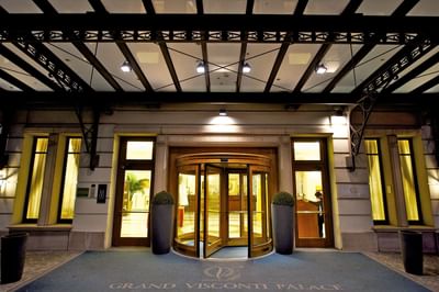 Front exterior view of the main entrance with canopy at Grand Visconti Palace