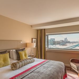 Interior of a bedroom with city view at Guoman Hotels