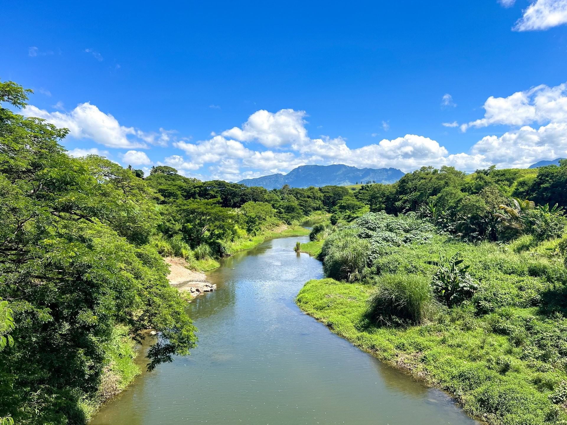 Lush green valley with a river and mountains in the Garden of the Sleeping Giant near TokaToka Resort Nadi Fiji