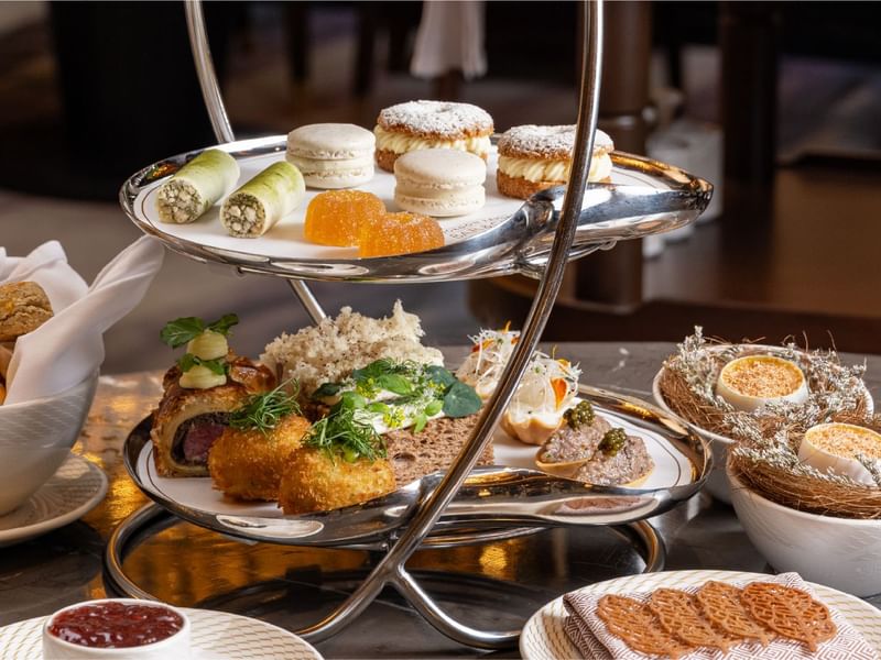 Three-tiered stand filled with savory and sweet treats for afternoon tea at Sunway Resort