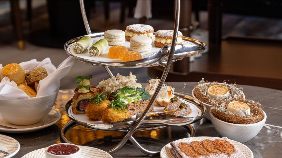 Three-tiered stand filled with savory and sweet treats for afternoon tea at Sunway Resort