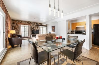 Kitchen and dining table by TV lounge area in Superior Suite at Hotel Port Royal