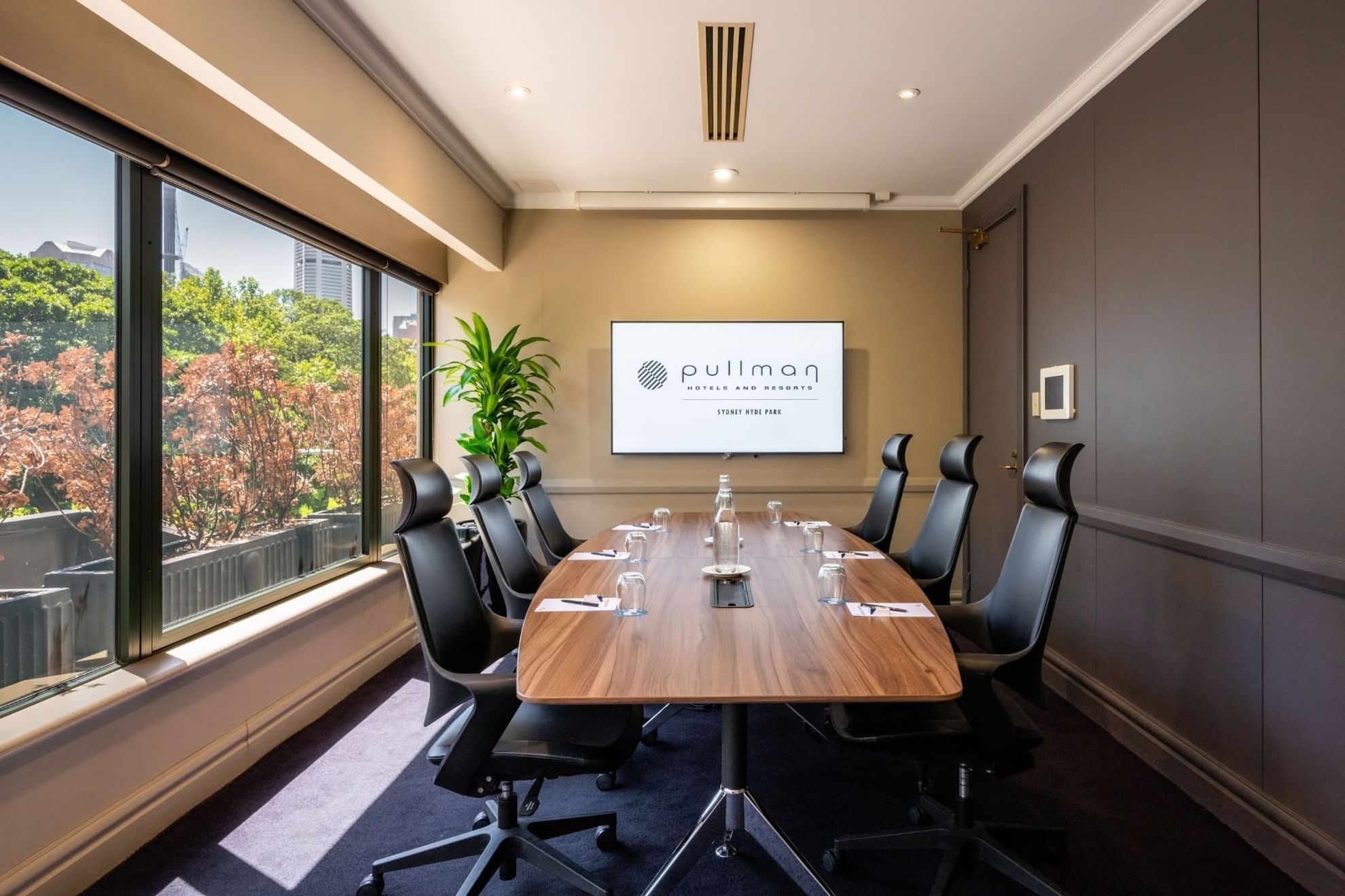 Boardroom set-up with TV in Busby Room at Pullman Sydney Hyde Park