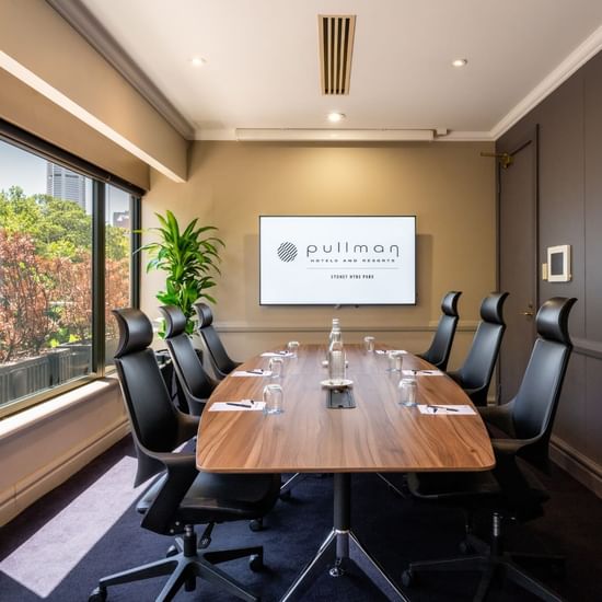 Boardroom set-up with TV in Busby Room at Pullman Sydney Hyde Park