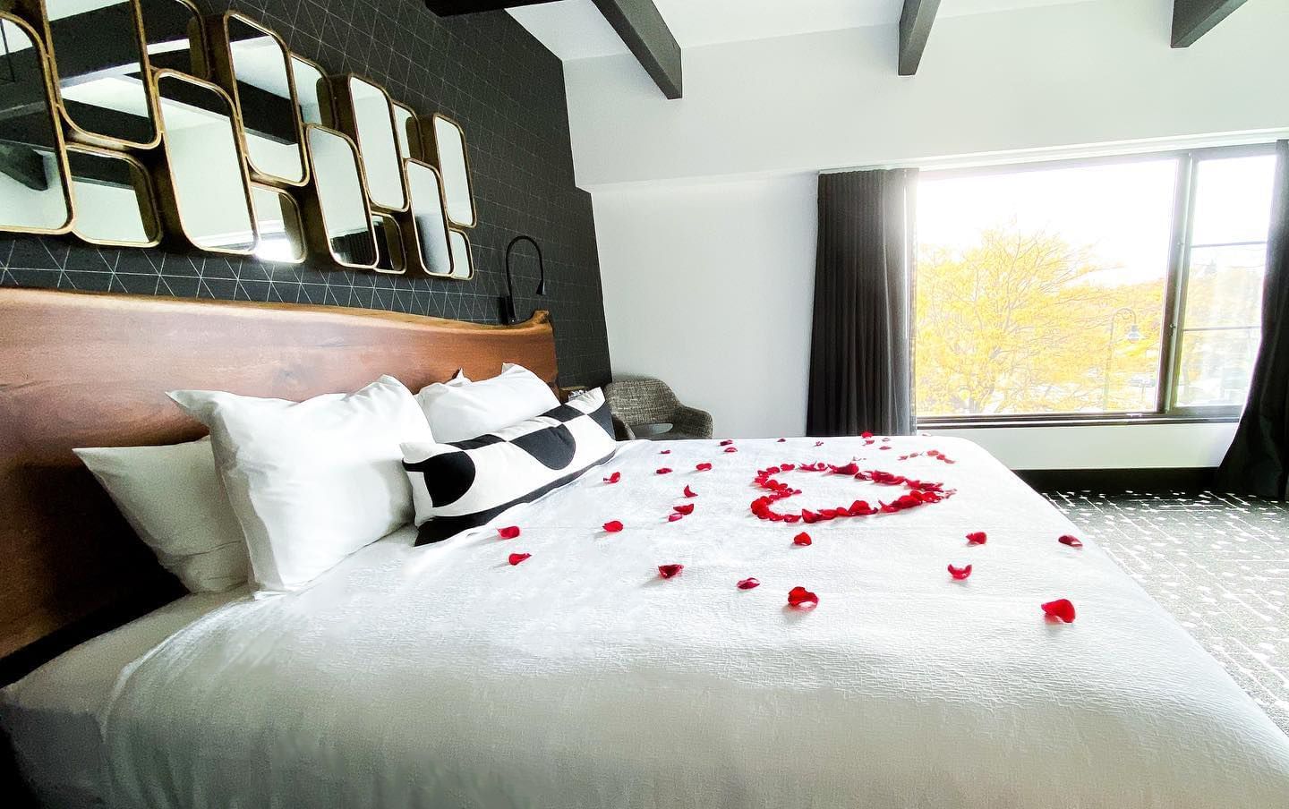 Rose petal turndown arranged on the bed in a Suite at Hotel Earl