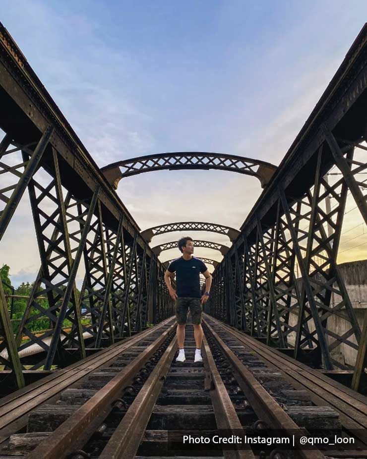 A man was taking a picture on the Ipoh Victoria Bridge - Lexis Suites Penang