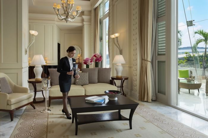 Staff member arranging a lounge area at The Fullerton Hotel Singapore