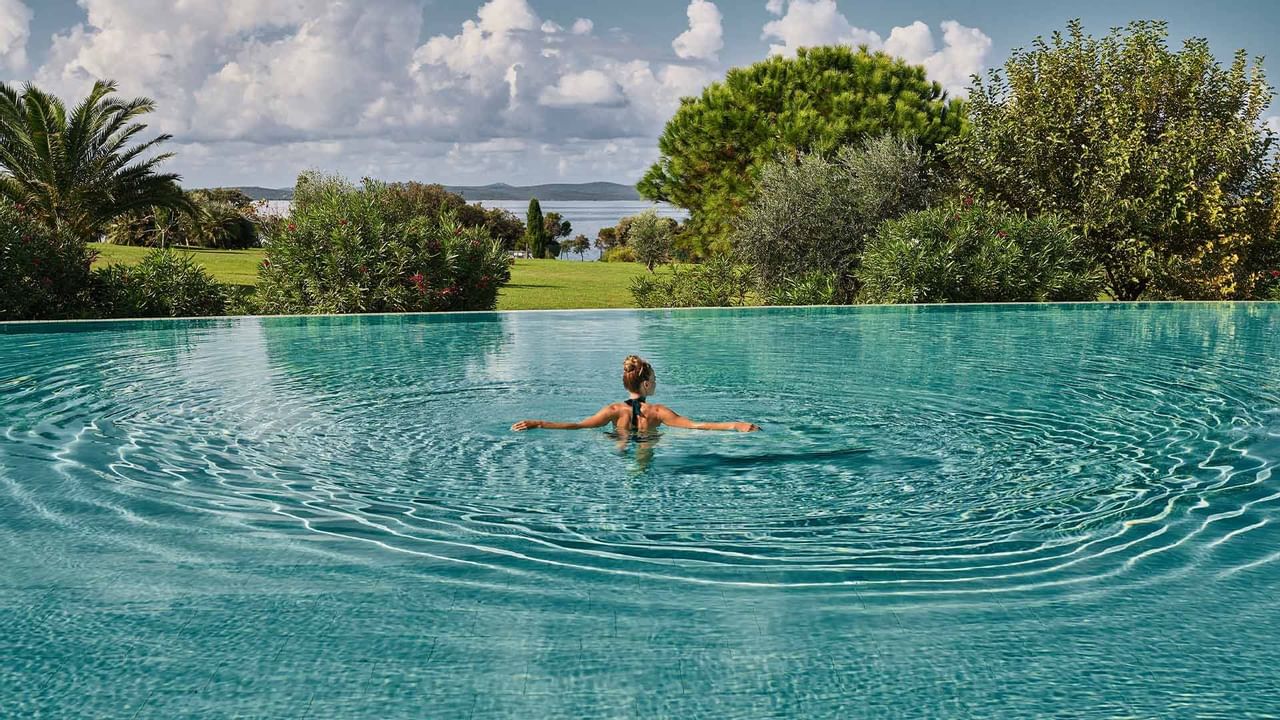 A lady enjoying the infinity pool at Falkensteiner Hotel Iadera