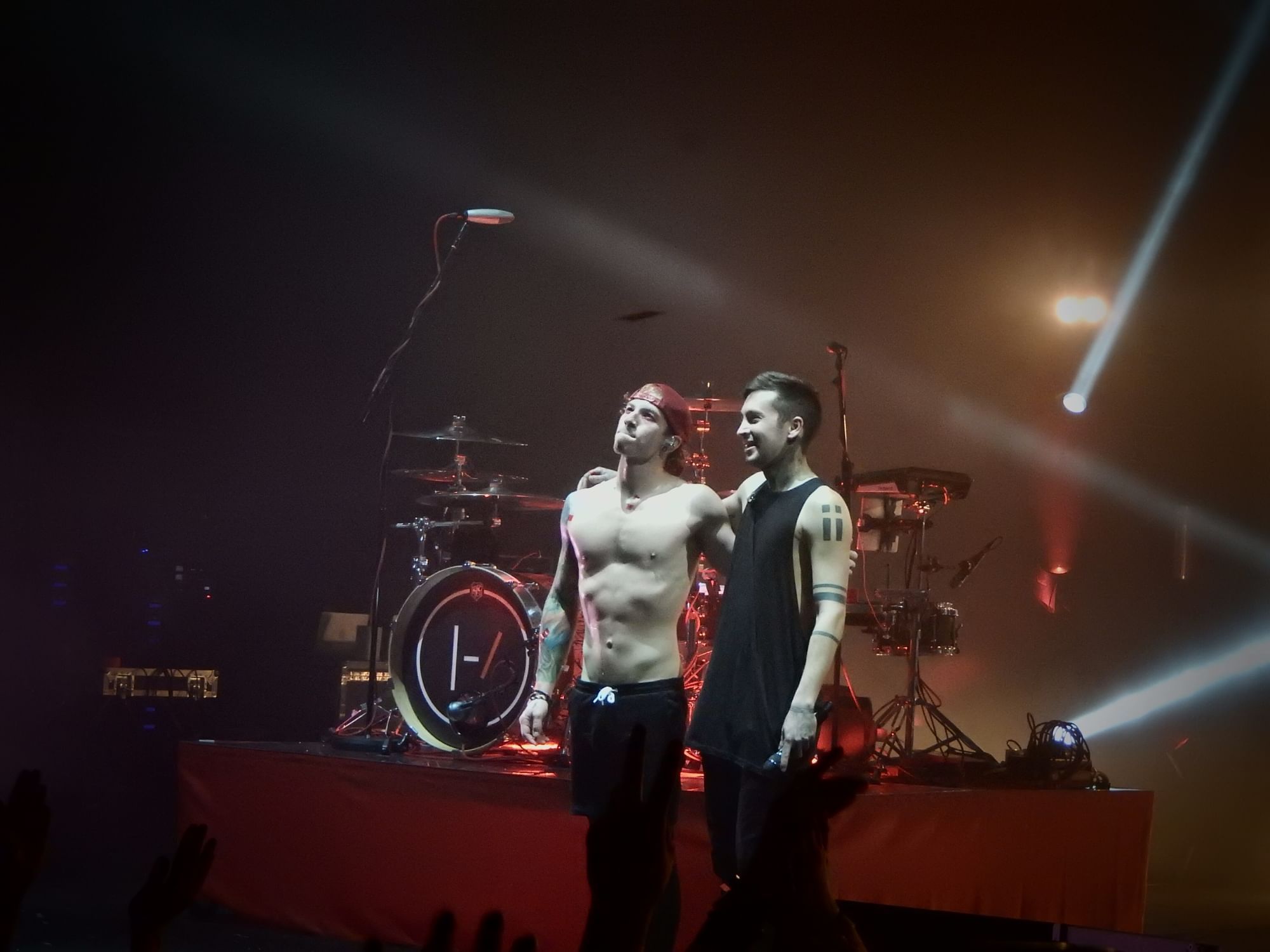 Musical duo Twenty One Pilots standing onstage at a concert.