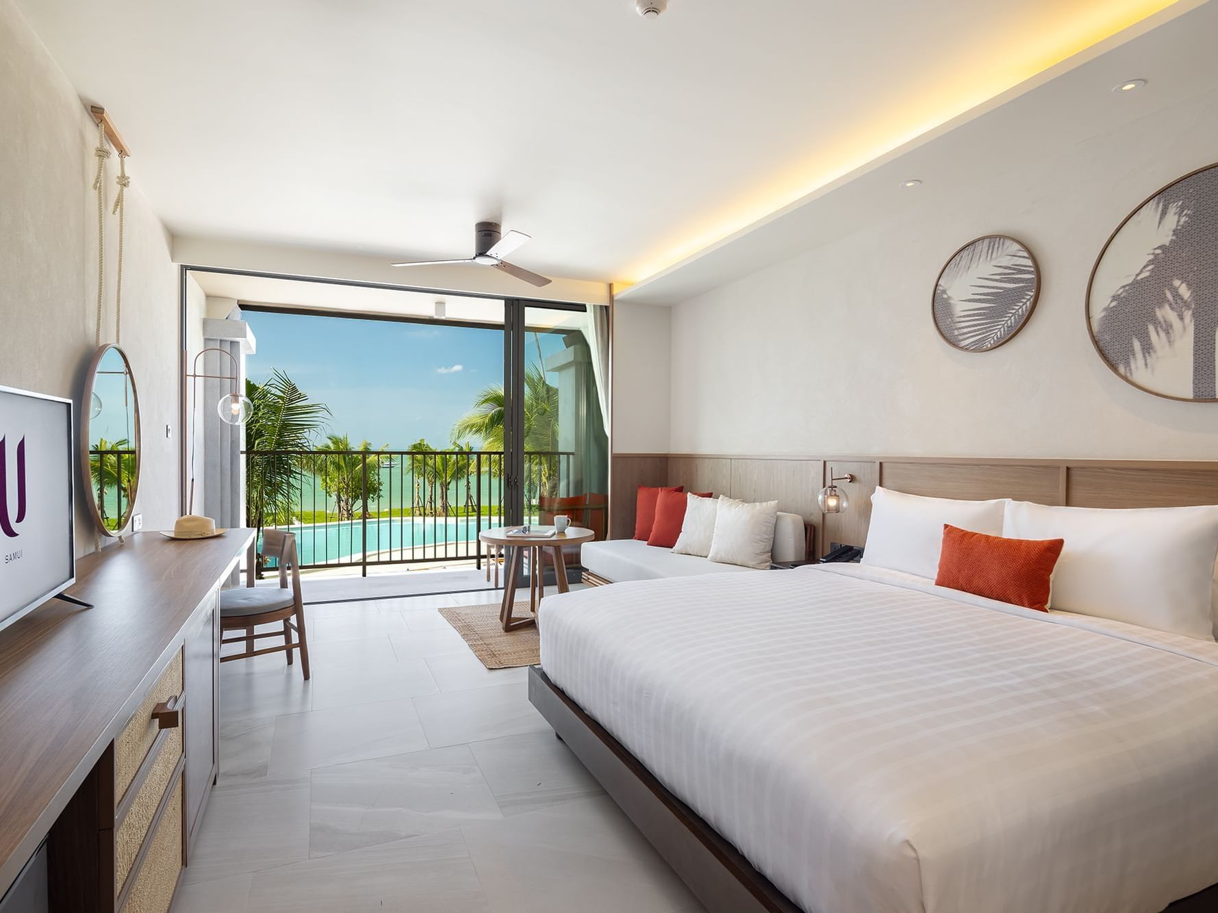 King-size bed & a TV in Deluxe Seaview room at U Hotels