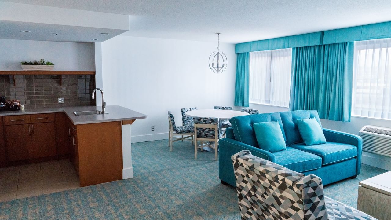 Sofa and kitchen in hotel suite