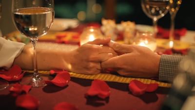 Hands of a Couple with champagne and rose petals at Hotel Sumaq