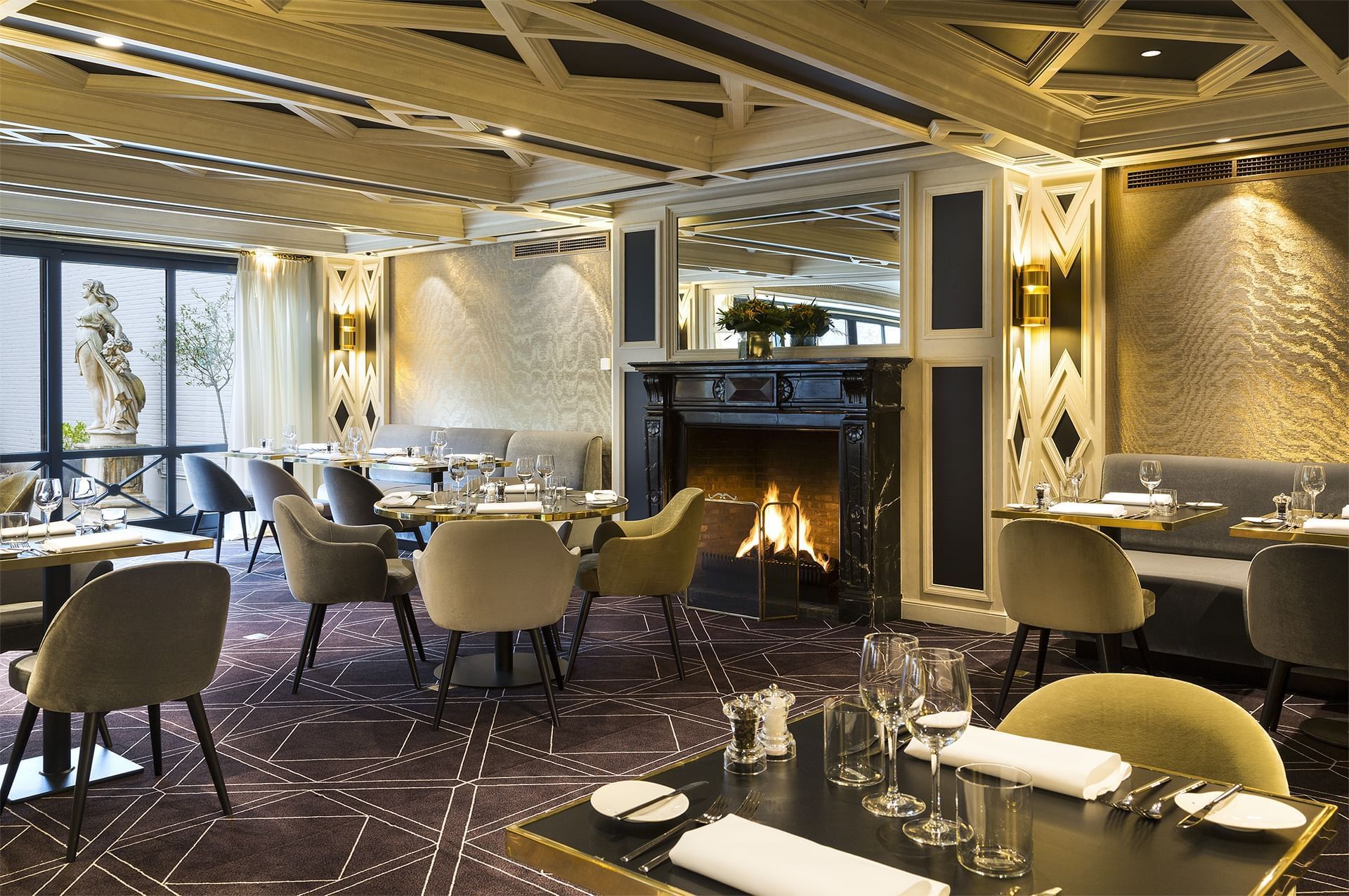 Fireplace by dining area in The Avenue restaurant at Hotel Barsey by Warwick - Brussels