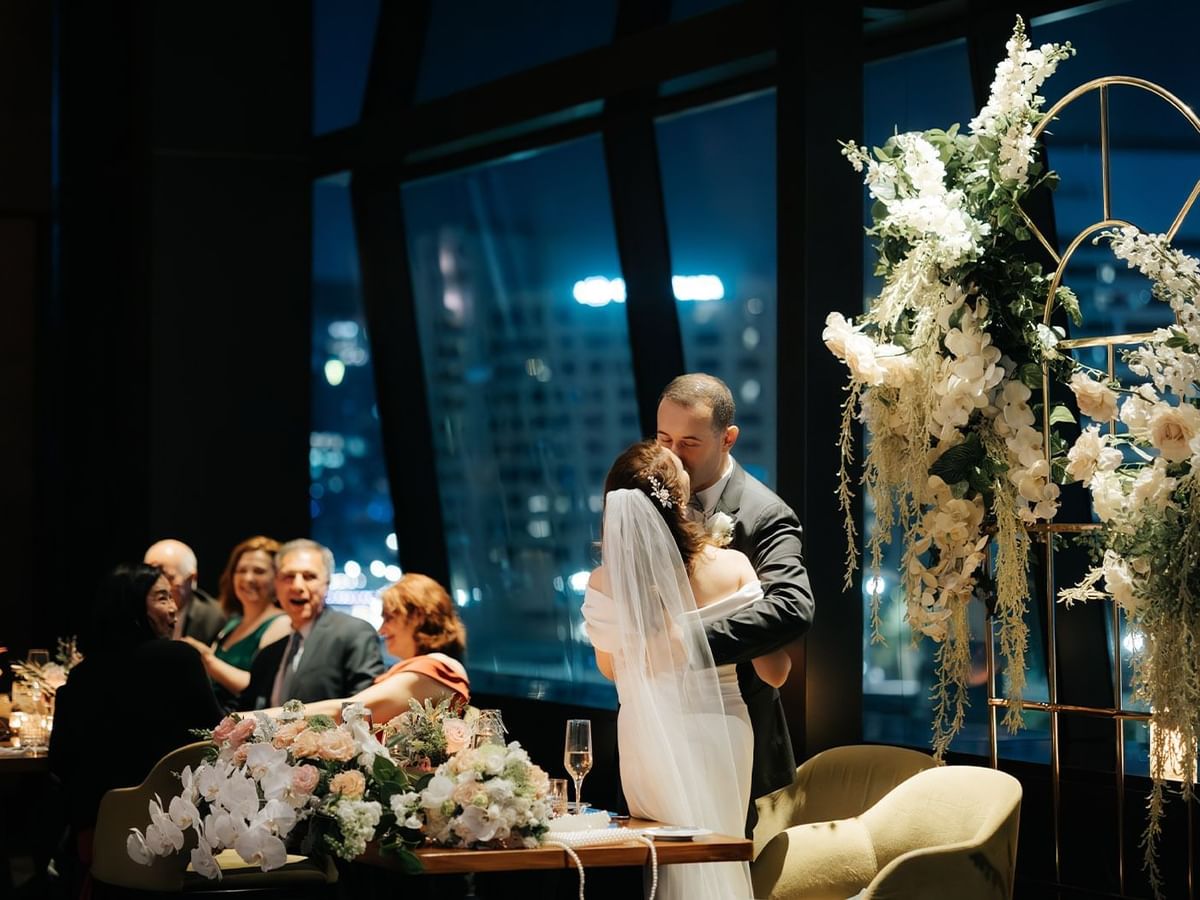 Anastasia & Pavel kissing at a wedding reception in Crown Towers Perth