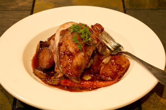 plate of roasted chicken with sauce