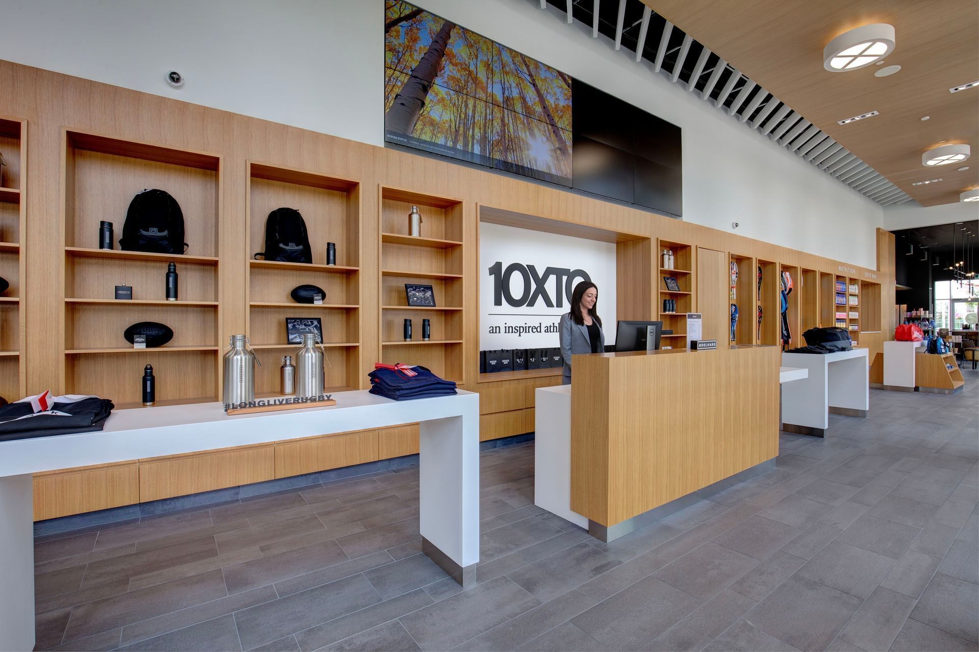 10XTO Athletic Club retail store with wooden shelves displaying products and a reception desk at Hotel X Toronto