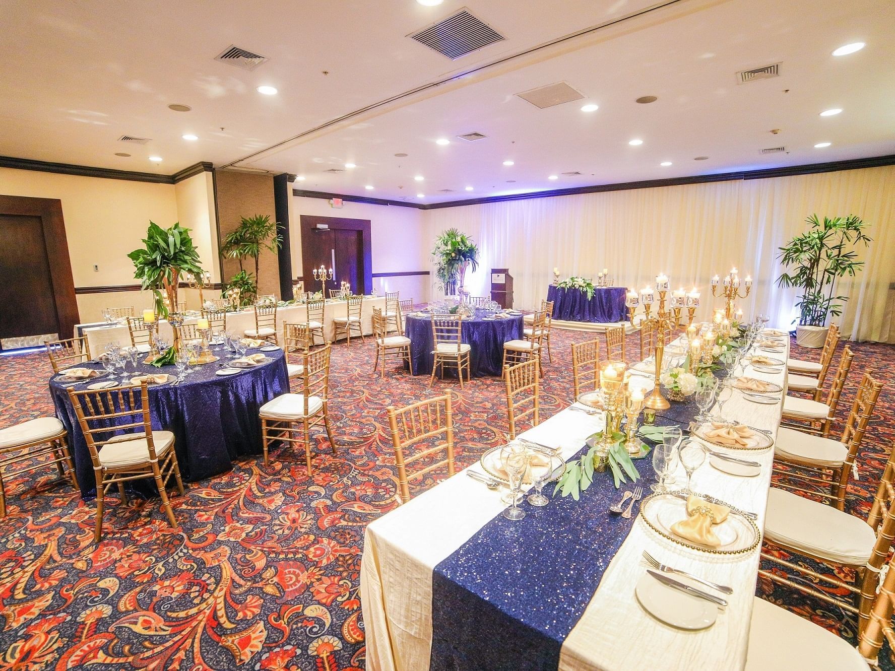 Table arrangement with blue and gold décor in Legacy Suite at Jamaica Pegasus Hotel