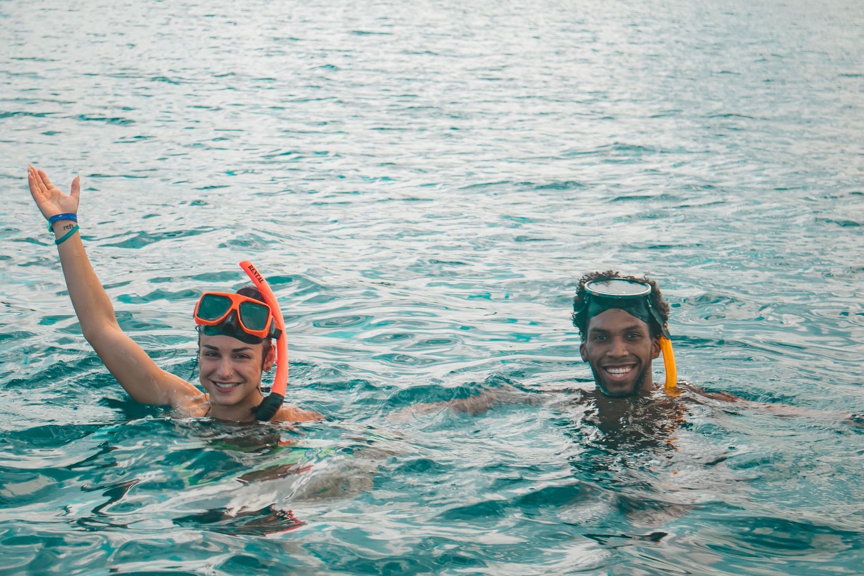 Two divers on water posing for a photo at Captains Watersports near Holiday Inn Resort Montego Bay
